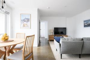 a living room with a table and a couch at The Lookout - Sunny St Kilda Contemporary in Melbourne
