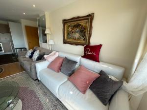 a living room with a couch with pillows on it at Executive Luxury 2 Bedroom Apartment - With underground parking in London