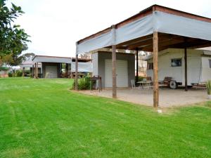 a pavilion with a picnic table in a yard at Excelsior Airstream Glamping in Porterville