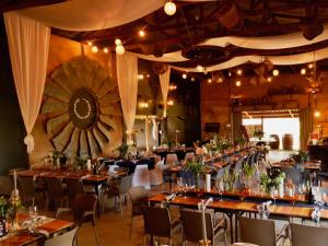 a large banquet hall with tables and chairs at Excelsior Airstream Glamping in Porterville