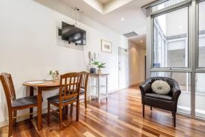 a dining room and living room with a table and chairs at Location meets Comfort near Bourke Street Mall in Melbourne