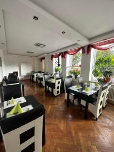 a dining room with tables and chairs in a restaurant at Hotel Deutscher Hof in Schleswig
