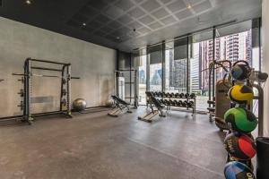 a gym with a lot of equipment in a building at Sky-High City Luxury with Huge Deck and Shared Pool in Melbourne
