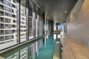 a swimming pool in the middle of a building at Sky-High City Luxury with Huge Deck and Shared Pool in Melbourne