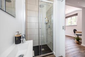 a bathroom with a shower and a sink at Angra Charming Suites by Seewest in Angra do Heroísmo