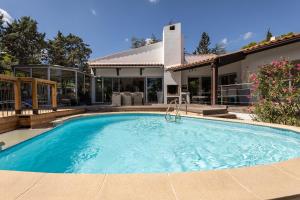 a swimming pool in front of a house at Villa Mercure in Cap d'Agde