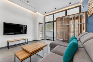 een woonkamer met een bank en een tv bij El Coloso Loft 1 in Benalmádena