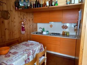 a small kitchen with a table and a stove at Casa Bizzo in Folgarida