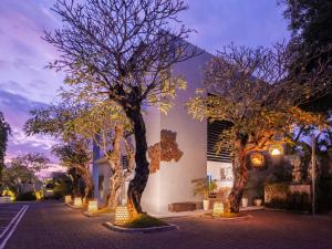a street with trees in front of a building at The Seminyak Suite - Private Villa in Seminyak