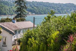 a house with a view of a body of water at Shell Cottage in Menai Bridge