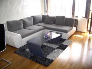 a living room with a couch and a coffee table at Luxury Panoramic Seaside Apartment in Burgas City