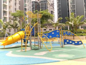 a playground with a slide in a pool at Palmyra Residence in Kajang