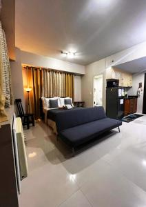 a living room with a bed and a kitchen at Studio 7th FL with Balcony across Terminal 3 Airport in Manila