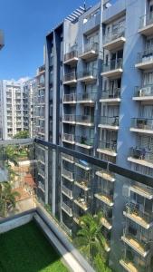 an apartment building with balconies and a yard at Studio 7th FL with Balcony across Terminal 3 Airport in Manila