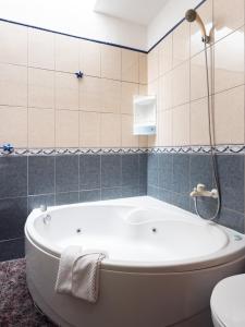 a bath tub in a bathroom with blue tiles at Live Icod Buen Paso in Icod de los Vinos