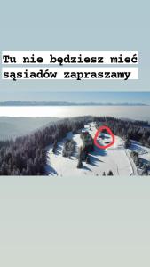 an aerial view of a ski resort in the wilderness in the snow at Gościniec Dziubasowki in Nowy Targ