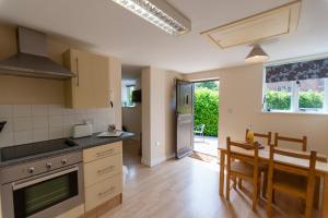 a kitchen and dining room with a table and chairs at Five Cottages in AONB and a Hobbit House! in Canterbury