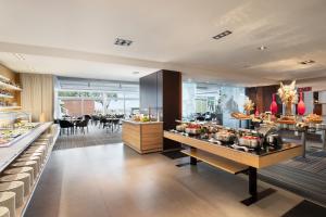 a restaurant with a buffet of food on display at Le Méridien Beach Plaza in Monte Carlo