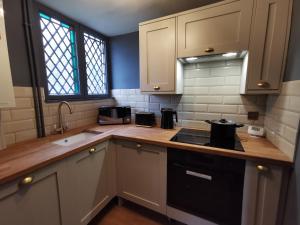 a kitchen with white cabinets and a counter top at Manor by the Lake in Cheltenham