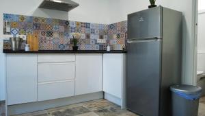 a kitchen with white cabinets and a refrigerator at SUITE ORQUIDEA in Benalup Casas Viejas