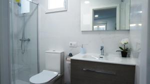 a bathroom with a toilet and a sink and a shower at SUITE ORQUIDEA in Benalup Casas Viejas