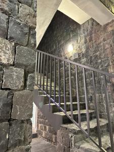 a staircase in a stone building with a stone wall at JA view chalet in Duwaykhīlah
