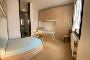 Dormitorio pequeño con cama y espejo en Villa Ambra B&B Siviglia, en Vermezzo