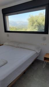 A bed or beds in a room at Casa rural Atalanta de la Vera