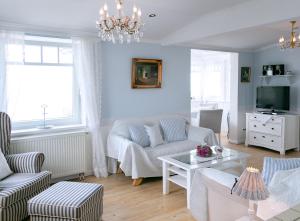 a living room with a couch and a tv at Villa Hansa am Meer in Timmendorfer Strand +71 photos