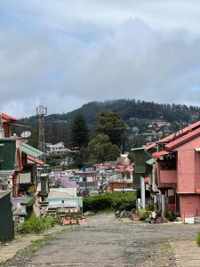 a view of a town with buildings and a mountain at Sumana Stays in Ooty