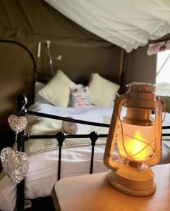 a lantern on a table in a bedroom with a bunk bed at Seven Hills Hideaway - Blorenge in Llanvetherine