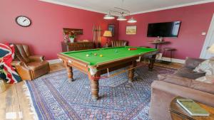 a living room with a pool table at Ty Castell in Beaumaris