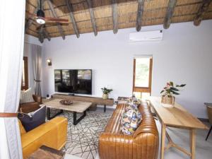 a living room with a couch and a table at Kruger Park Lodge Unit 538 - PmP in Hazyview