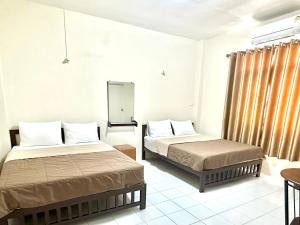 A bed or beds in a room at PD Hostel