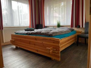 een groot bed in een kamer met ramen bij Ferienhaus Krakow am See in Krakow am See