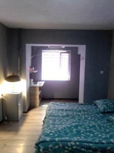 a bedroom with a bed and a window at A cozy bedsit! in Tashkent