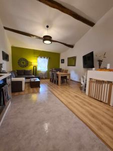 a living room with a couch and a table at Maison le trèfle in Chef-Boutonne