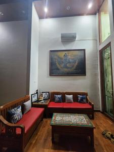 Sala de estar con 2 bancos y mesa en Tumungkul Homestay, en Jejeran