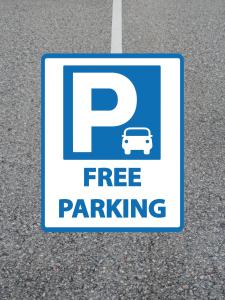 a sign that says free parking on the street at Comfortable City Apartment in Derby