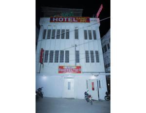 a building with two motorcycles parked in front of it at HOTEL SANDS INN, Jodhpur in Jodhpur