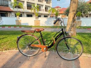 a bike parked on a sidewalk next to a street at President Hotel Udonthani in Udon Thani