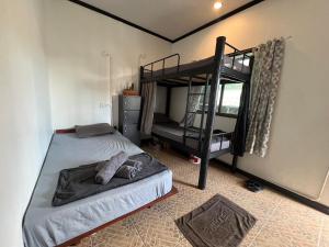 a bedroom with a bunk bed and a bunk bed at U Hostel Koh Phangan in Haad Rin