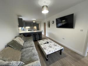 a living room with a couch and a table at 4 bedroom House Boston Lincs Pet & Child friendly in Boston