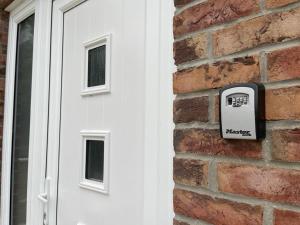 a mailbox on a brick wall next to a door at 4 bedroom House Boston Lincs Pet & Child friendly in Boston