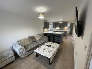 a living room with a couch and a table at 4 bedroom House Boston Lincs Pet & Child friendly in Boston