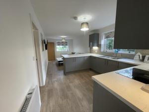 a large kitchen with white counters and a counter top at 4 bedroom House Boston Lincs Pet & Child friendly in Boston