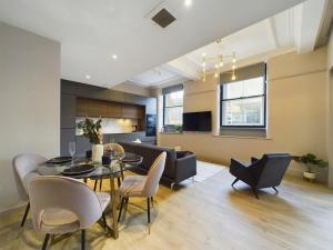 a dining room and living room with a table and chairs at Luxury Unique 2bedroom city centre in Manchester