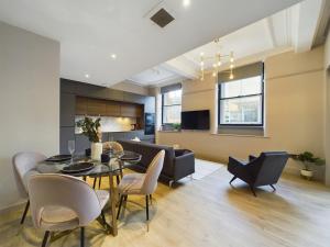 マンチェスターにあるLuxury Unique 2bedroom city centreのテーブルと椅子のあるダイニングルームとリビングルーム