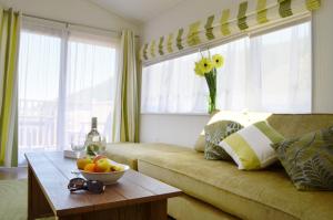 sala de estar con sofá y mesa con un bol de fruta en Bovisand Lodge Holiday Park en Plymouth