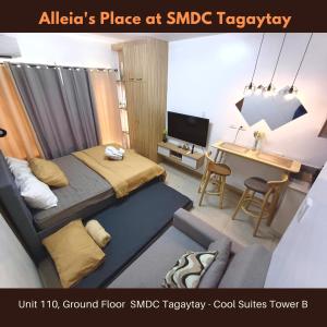 a small bedroom with a bed and a desk at Alleia's Place at Tagaytay in Tagaytay